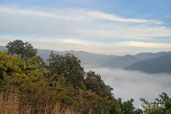 高清摄影 远处一座山峦的景色，云层低垂。