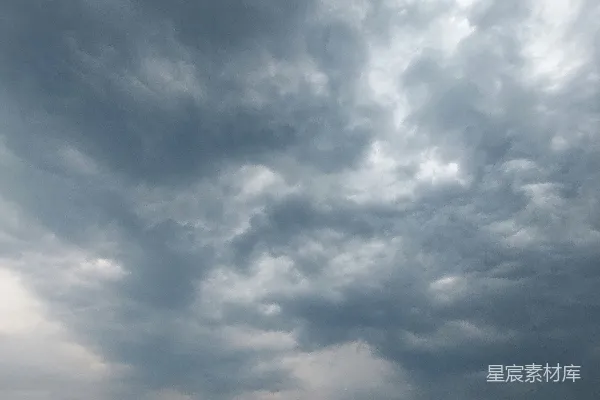 高清摄影 一群人在海滩上站着，天空中有乌云。