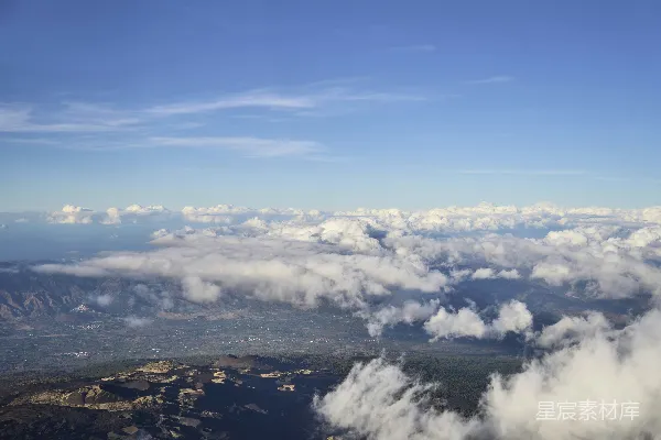 高清摄影 蓝天之下，山峦之间漂浮着云朵。