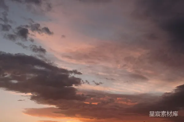 高清摄影 夕阳下的多彩云朵，呈现出粉色和橙色的色彩。