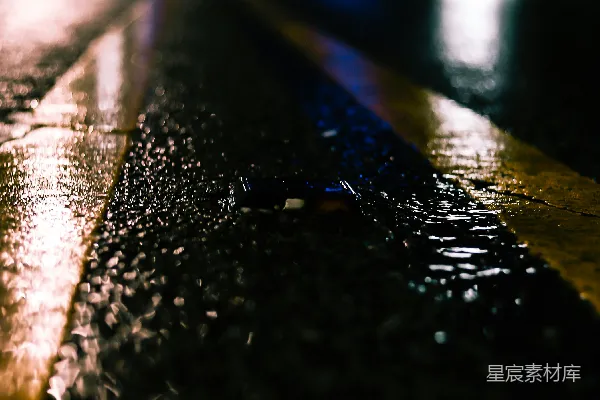 高清摄影 夜晚湿漉漉的路上有灯光反射在里面。