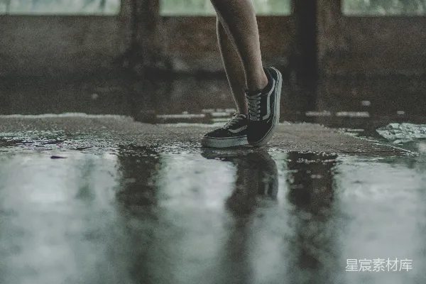 高清摄影 穿着黑Vans运动鞋的人在湿滑的路面上行走