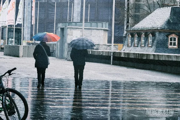 高清摄影 一群人在街上行走，手中拿着雨伞。