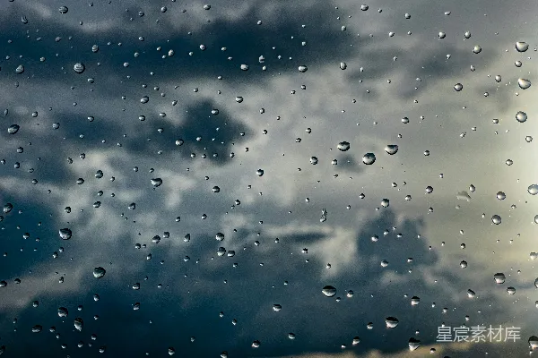 高清摄影 雨滴落在一片阴云密布的天空背景上的玻璃窗上