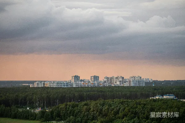 高清摄影 夕阳下的绿树与城市建筑