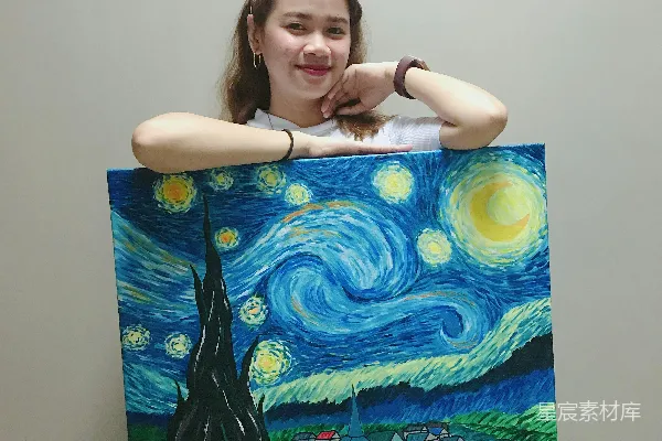 高清摄影 微笑的妇女站立着并拿着梵高创作的《星夜》油画。