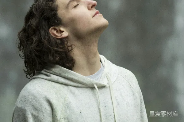 高清摄影 灰毛衣的男子闭眼时抬头凝视着前方