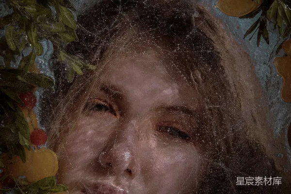 高清摄影 一个女人的脸被橙子和树叶环绕