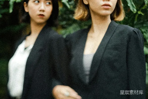 高清摄影 黑色连衣裙的女人站在绿色叶子植物旁边