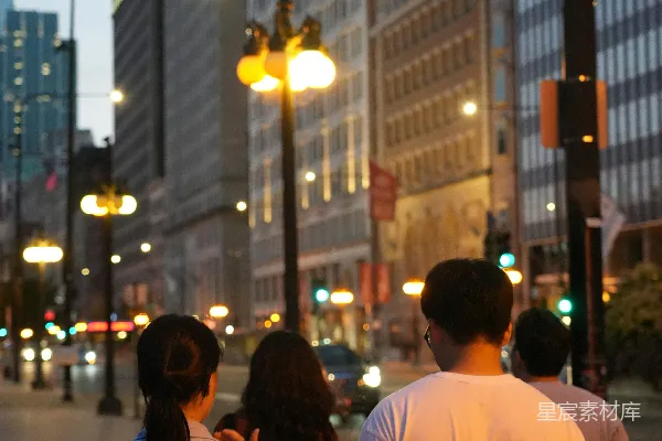 高清摄影 城市街道上人们在黄昏时 walking。