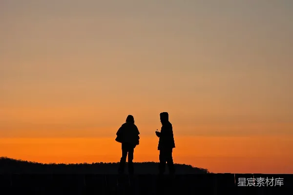 高清摄影 两人 silhouette 对应橙色的夕阳 sky。