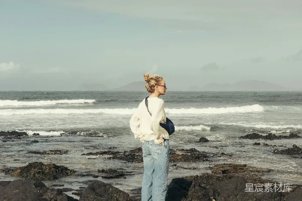 高清摄影 女人站在海边的岩石上