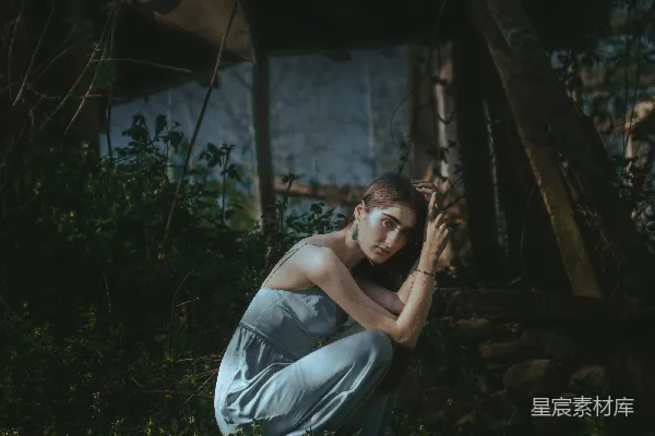 一个男人跪在树旁的草地上