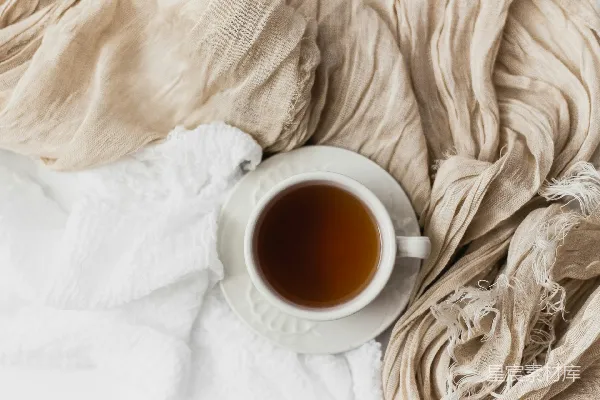 高清摄影 白瓷茶杯中装满了茶，置于白瓷托盘上。