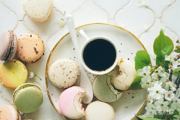 高清摄影 圆白陶瓷盘中摆放着 macarons，旁边是茶杯和汤匙。