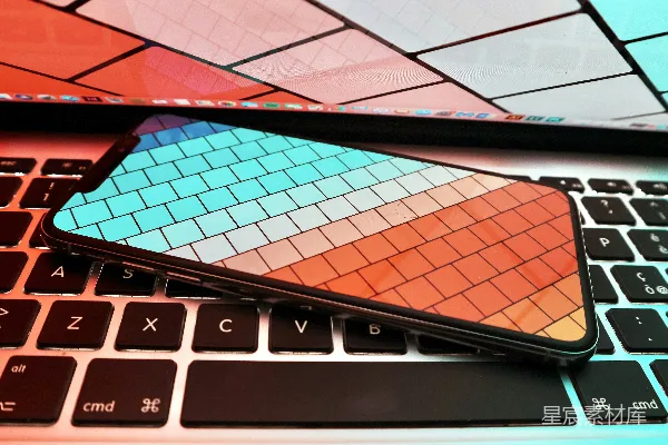 高清摄影 黑色智能手机放在MacBook Pro上