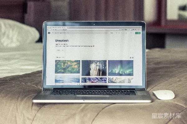 高清摄影 灰黑色的MacBook Pro放在床上。