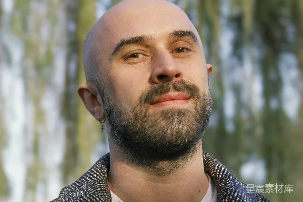 高清摄影 一个光头的男人自信地在户外摆姿势。