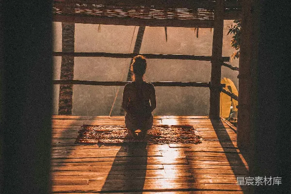 高清摄影 女士在地板上打坐， overlooking 看得见远处的树木