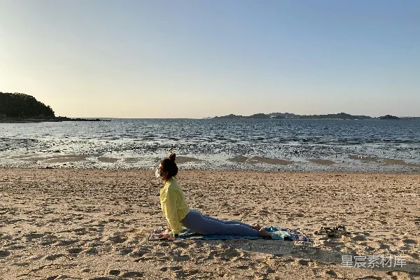 高清摄影 身穿黄色上衣和蓝色裤子的女人坐在海滩边缘的白天
