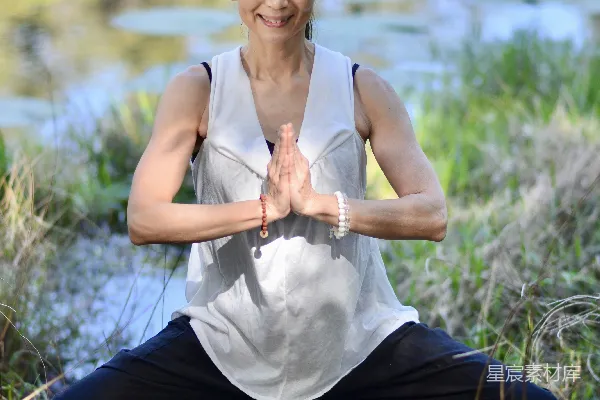 高清摄影 一个女人在水边做瑜伽。