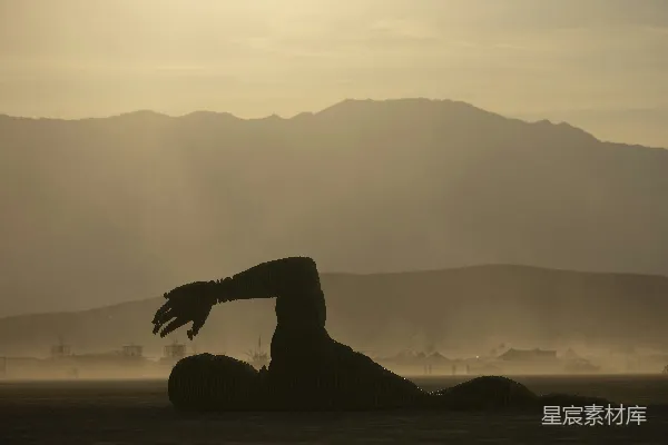 高清摄影 游泳者 silhouette 在模糊的山峦背景中。