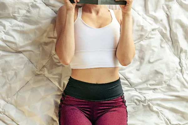 高清摄影 一个女人躺在床上看书。