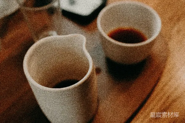 高清摄影 白色陶瓷茶杯放在棕色木桌上