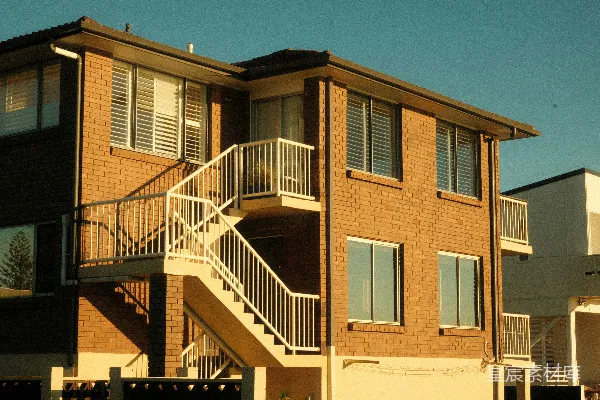 高清摄影 带有一个带扶手的白色室外楼梯的住宅砖砌建筑。