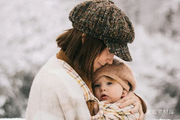 高清摄影 一位抱着用毯子包裹着婴儿的女性