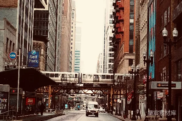 火车横跨一座城市的街道，旁边是建筑物。