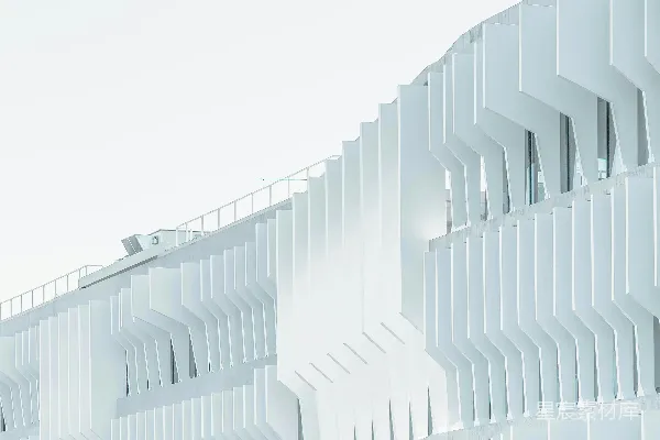 高清摄影 白天，云层中有一座白色高层建筑。