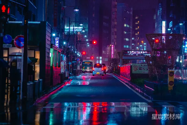 高清摄影 夜晚高楼大厦之间的道路上行驶的汽车