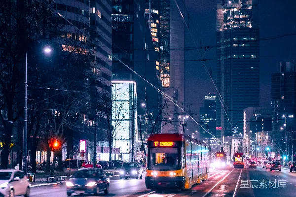 高清摄影 夜晚高楼大厦之间的道路上行驶的汽车
