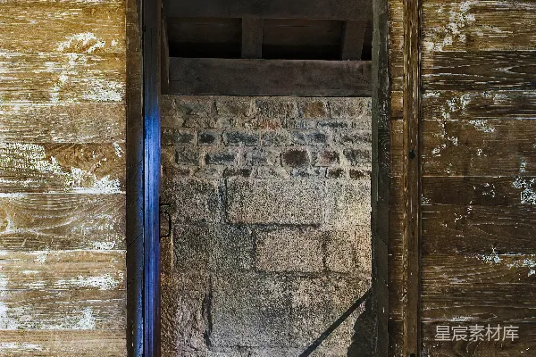 高清摄影 一座木制建筑旁的砖墙前有一扇敞开的门。