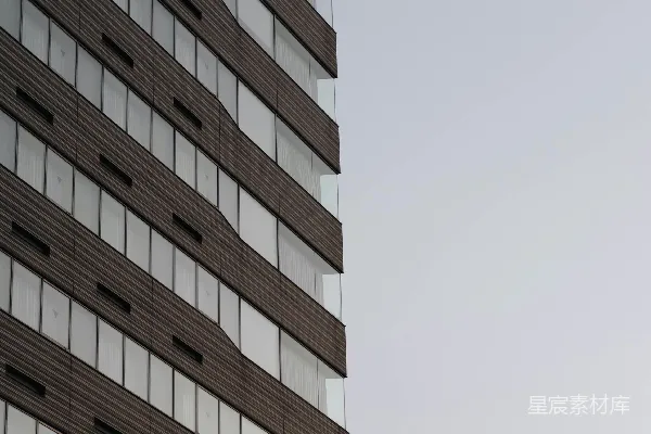 高清摄影 现代建筑立面，带有重复的窗户和深色面板。