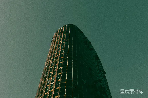 高清摄影 弯曲的摩天大楼与蓝绿色的天空相映成趣