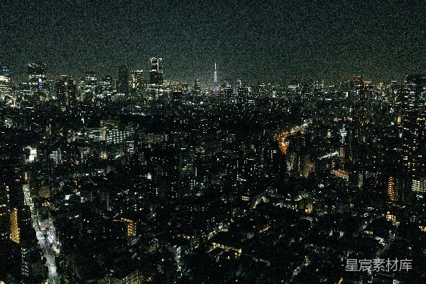 城市夜景灯火辉煌，远处有一座塔在发光。