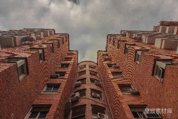 高清摄影 仰望砖砌的建筑物，背景是阴云密布的天空。