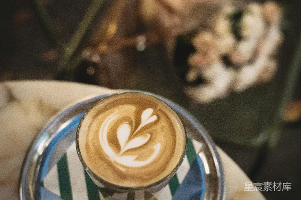 玻璃杯中的拿铁艺术放在托盘上