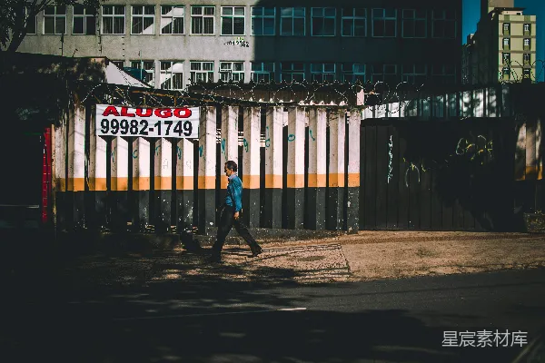 高清摄影 白天，一个人在建筑物附近行走。
