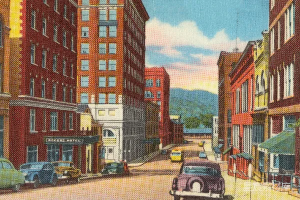 高清摄影 白天，棕色建筑旁停着几辆车。