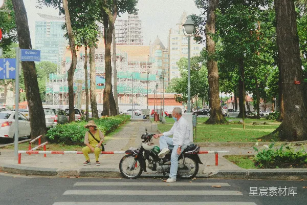高清摄影 一个骑摩托车的人在人行横道处停下。