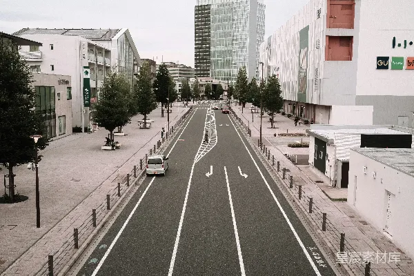 高清摄影 一条长长的空荡荡的城市街道，两旁是高大的建筑物。