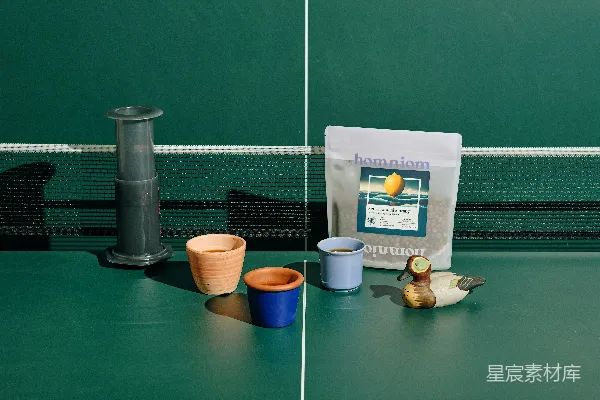 桌子上放着一个装满咖啡的袋子旁边是一杯茶。