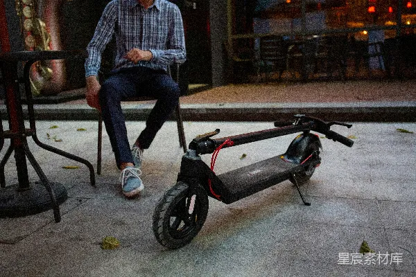 一个男人坐在一辆滑板车上