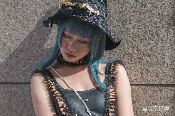 高清摄影 穿女巫服装的女人倚靠在灰色的墙上