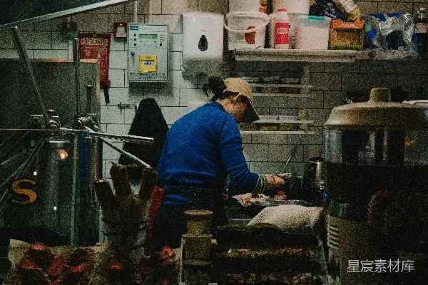 一个人在繁忙的餐馆厨房里烹饪。