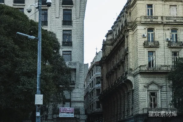 人们在街角等待，周围是建筑物。
