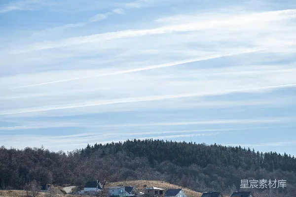 高清摄影 一片田野，远处的山丘上有一些建筑物。